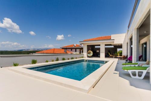 a swimming pool in the backyard of a house at Villa Bay View in Stari Grad