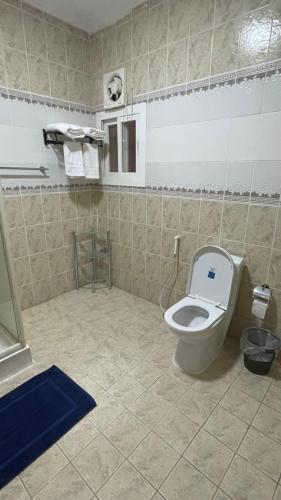 a bathroom with a toilet with the lid up at اتش h5 ينبع الصناعية in Madīnat Yanbu‘ aş Şinā‘īyah