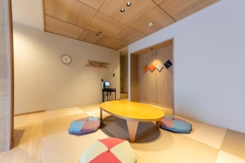 a dining room with a table and chairs at Irodori Hotel UGUISU in Fukuoka