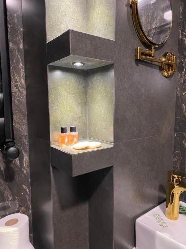a bathroom with a sink and a mirror at Hotel Villa Niko Mari in Tbilisi City