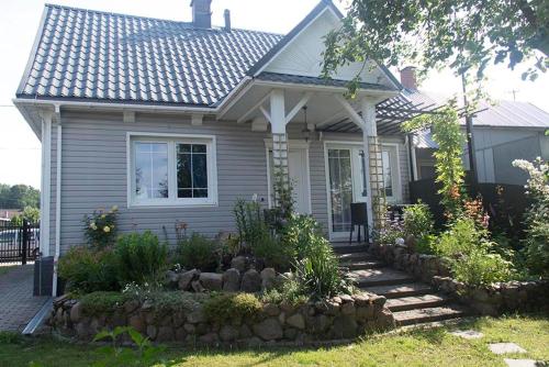 a small house with a rock garden in front of it at Domek w Narewce in Narewka