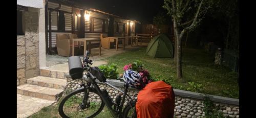 a bike parked in front of a house at night at Holiday Park Tajoraft in Konjic