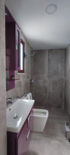 a bathroom with a sink and a bath tub at Aleks Holiday Rooms in Ksamil