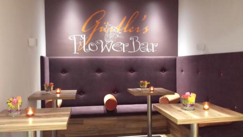 a purple couch with a sign that says girls flower bar at Stadthotel Gürtler in Amstetten