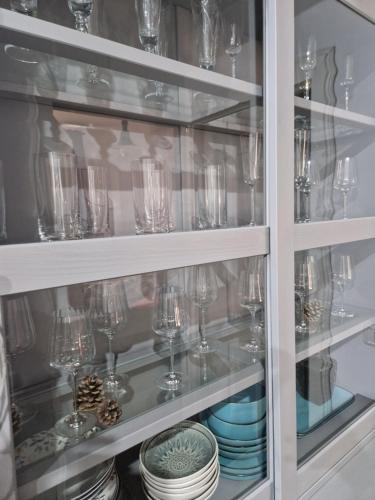 a glass cabinet filled with glasses and plates at Sinaia Veche in Sinaia