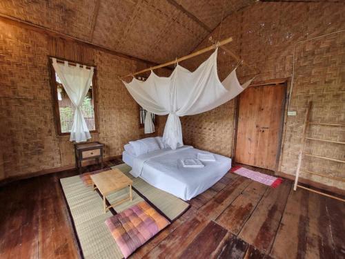 a bedroom with a bed with a mosquito net at Nongtao Homestay in Chiang Mai