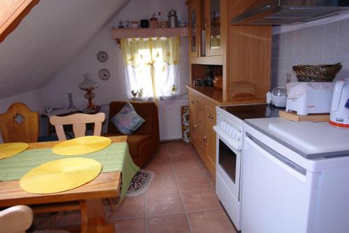 a kitchen with a table and a dining room at Ferienwohnung Bimmelbahn-Blick in Neudorf