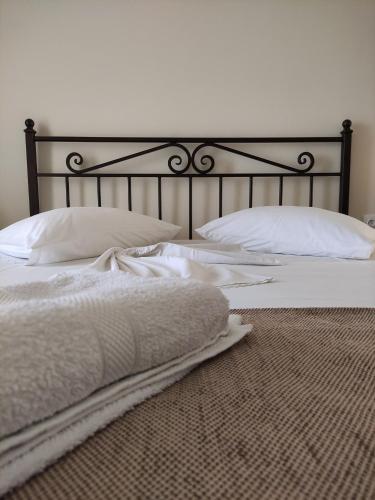 a bedroom with two beds with white sheets and pillows at Paradise Garden Paros in Piso Livadi