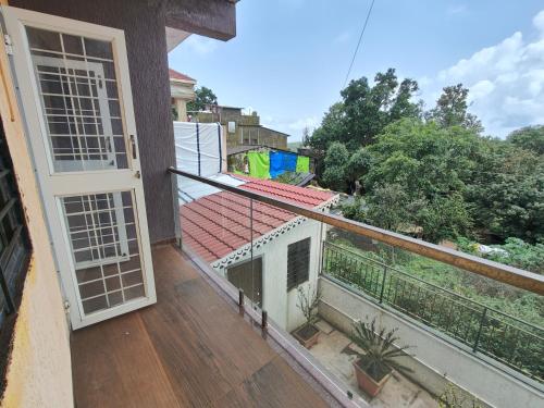 a balcony with a view of a house at Villa with valley view Panhala in Panhāla