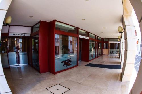 an entrance to a building with red columns and windows at Hotel dos Cavaleiros in Torres Novas