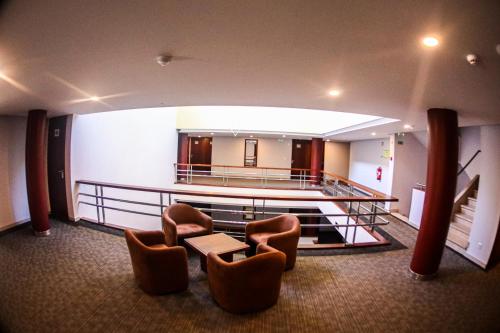 a lobby with chairs and a table in a building at Hotel dos Cavaleiros in Torres Novas