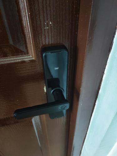 a black door handle on a wooden door at Best Inn Lahug in Cebu City