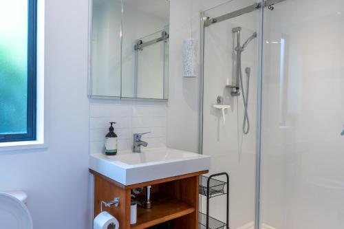 a bathroom with a sink and a shower at Firkins Retreat, Picton in Picton