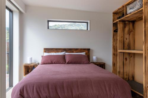 Un dormitorio con una cama grande y una ventana en Firkins Retreat, Picton, en Picton