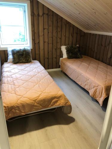 En eller flere senger på et rom på Storekleiv Hyttefelt Tuddal