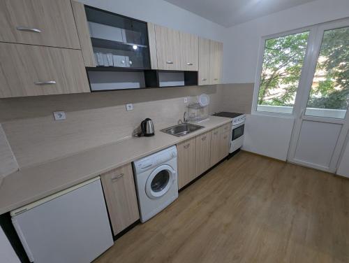 a kitchen with a sink and a washing machine at Апартамент Габи in Karlovo