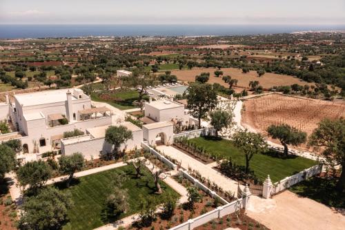 an aerial view of a large white building with a park at Masseria Auraterrae in Polignano a Mare