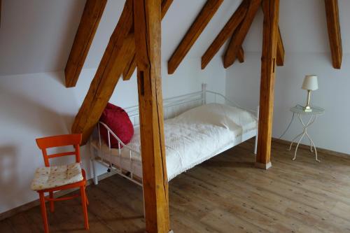 a small bedroom with a bed and a chair at Ferienwohnung & Wellness in Bad Kissingen
