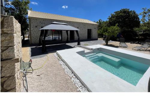 a swimming pool in a yard with a gazebo at The 10k Stones Villa in Corfu
