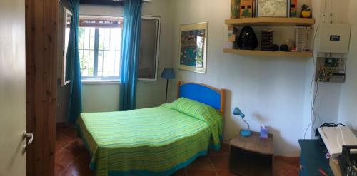 a small bedroom with a bed and a window at Sol Invictus Est in Serranova