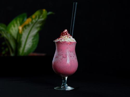 a pink drink with a straw in a glass at Maaniya Palace in Maamigili