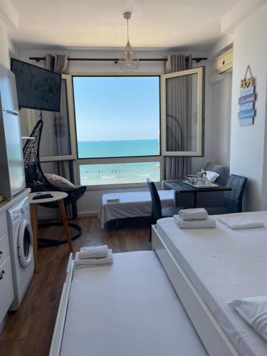 a room with two beds and a view of the ocean at Arteg Apartments - Full Sea View in Durrës