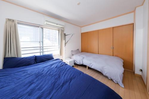 a bedroom with two beds and a window at Grace Heiwajima by Tranova in Tokyo