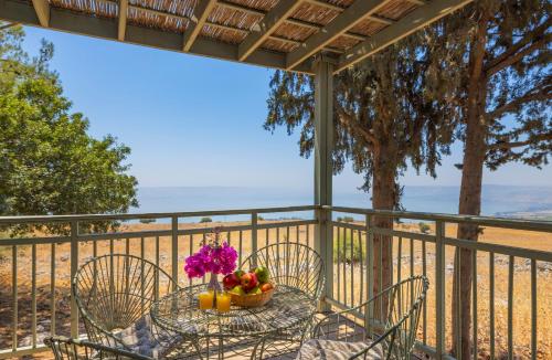 a table with a bowl of fruit on a balcony at Vered Hagalil Holiday Village Hotel in Chorazim
