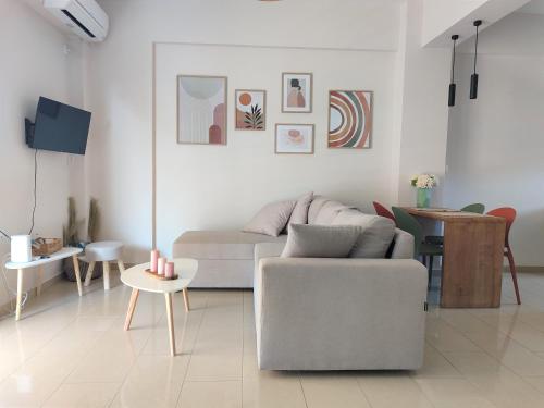 a living room with a couch and a table at Orfhl Studio in Mesolongion