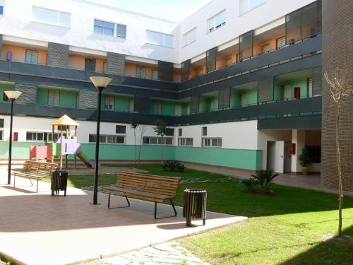 a building with a park bench in front of it at l4 in Santiponce