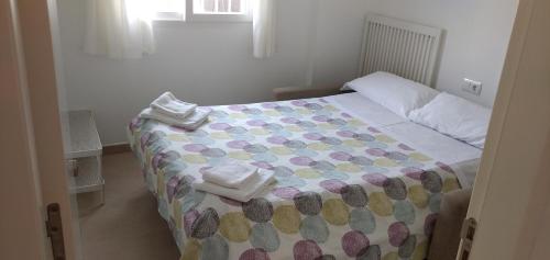 a bedroom with a bed with towels on it at La Casita del pescador in Cabo de Palos