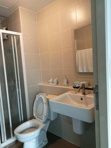 a bathroom with a toilet and a sink and a shower at DCondo hyde in Chiang Rai