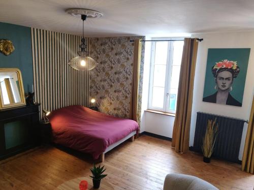 a bedroom with a red bed and a window at De Vert et d'Or - proche gare - parking - jardin in Saint-Brieuc