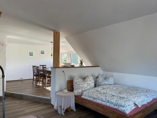 a bedroom with a bed and a dining room at Ferienwohnung Stille am Haff in Gummlin