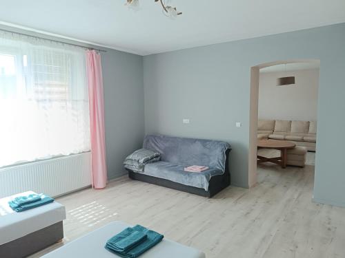 a living room with a couch in the corner of a room at Parkowe Ranczo in Poraj