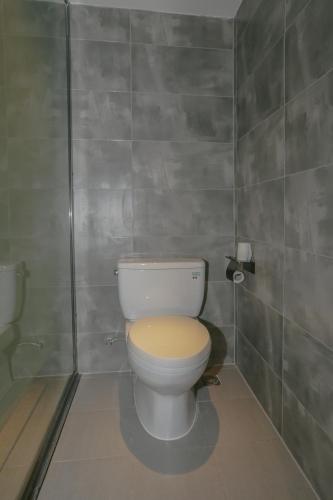 a bathroom with a white toilet with a wooden seat at Cozy Boutique Hotel in Zhangjiajie