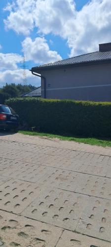 a car parked in a driveway next to a building at Elmarkos in Kolonia Chwaszczyńska