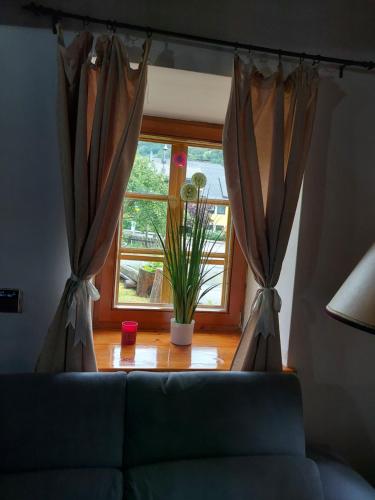 a living room with a couch and a window at Blue House in Ramingstein