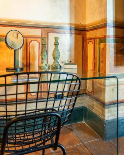a chair in a room with a table and vases at Castello di Limatola in Limatola