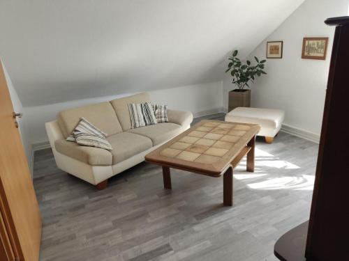 a living room with a couch and a coffee table at Unterkunft Mau in Rotenburg an der Wümme