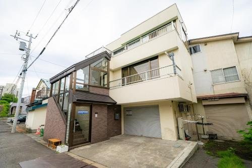 an apartment building with a parking lot in front of it at Ota Building - Vacation STAY 14022 in Otaru