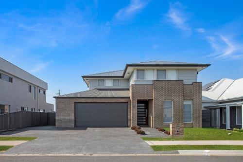 a brick house with a garage on a street at 7 Aurora Ave Dunmore in Dunmore