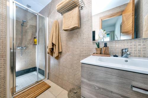 y baño con lavabo y ducha. en Casa Costa Esmeralda Plus-Pool and Relax, en Costa Teguise