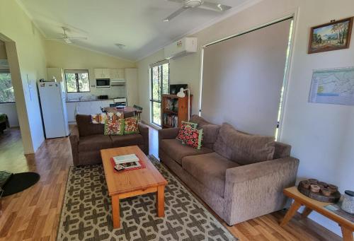 a living room with two couches and a coffee table at Bellthorpe Stays in Maleny