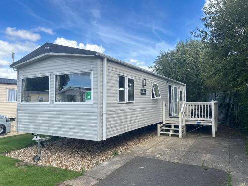 a white tiny house sitting in a yard at Butlins Skegness Caravan in Lincolnshire