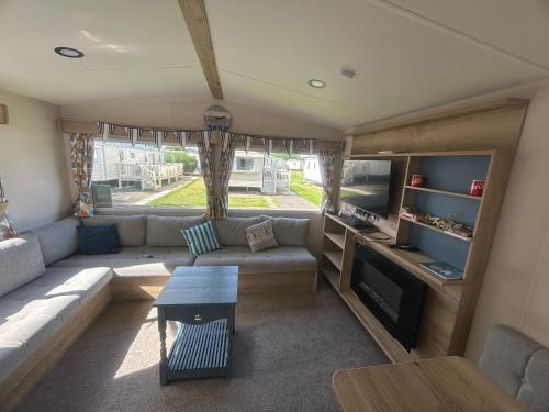 a living room with a couch and a table at Butlins Skegness Caravan in Lincolnshire