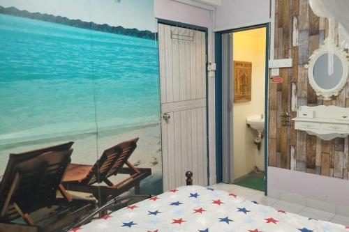 a bedroom with a view of the ocean at Comfy Home Near to Penang Hill in Ayer Itam