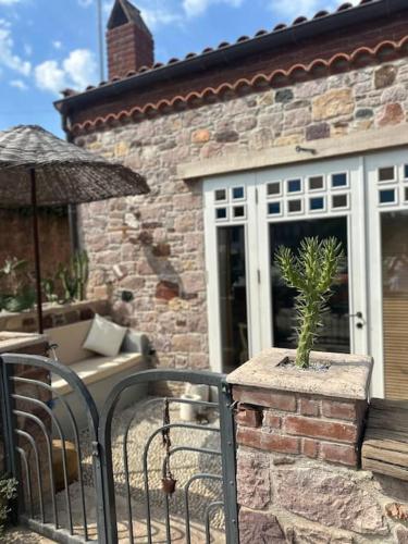 a brick house with a gate with a potted plant at Spitaki in Ayvalık