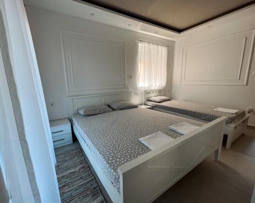 a bedroom with two beds and a window at Mavalux apartments in Tivat