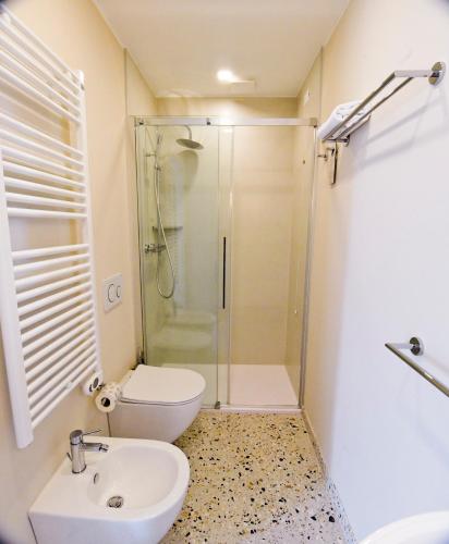 a bathroom with a shower and a toilet and a sink at Maison Boutique Al Redentore in Venice